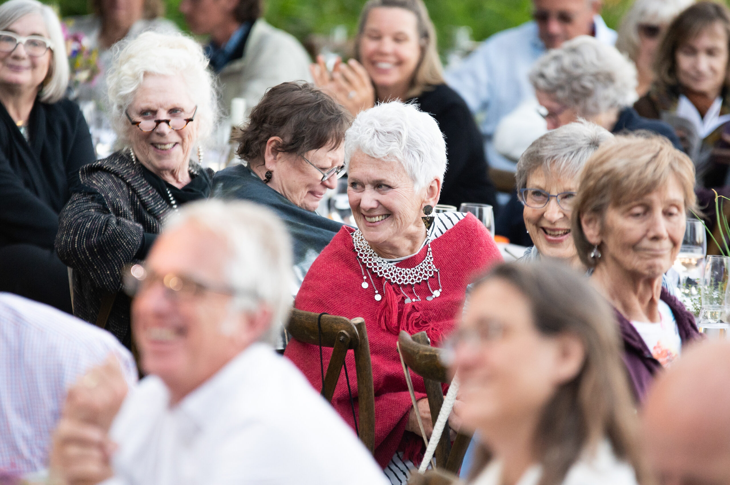 Our Long Table guests laughing at the dinner table