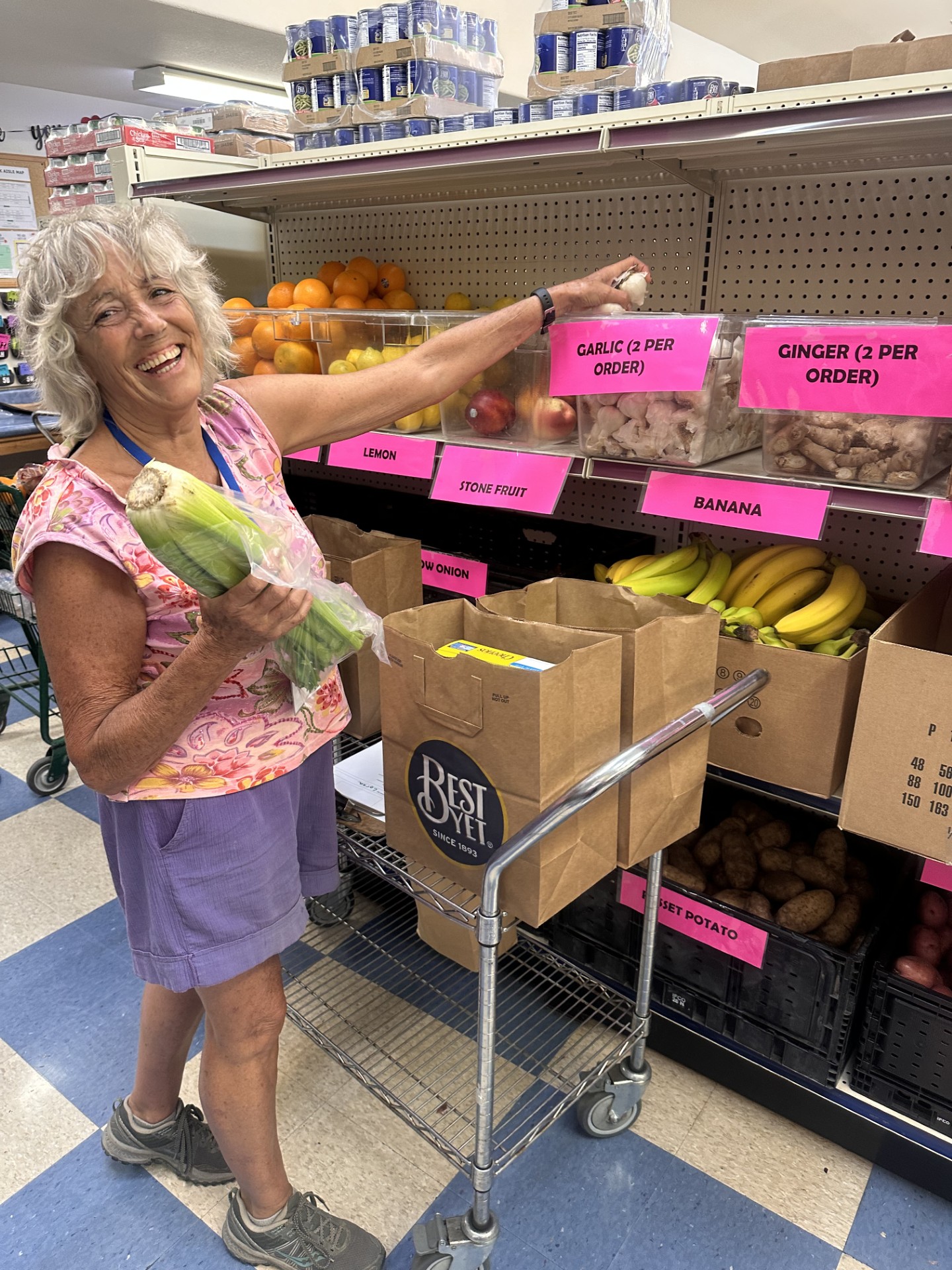 Food bank volunteer filling grocery bags with fresh produce